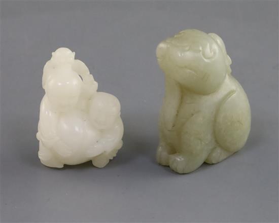 A Chinese white jade two boys carving and a celadon jade lion-dog, H. 3.7cm and 4.4cm